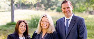 Photo of 3 team members in a field